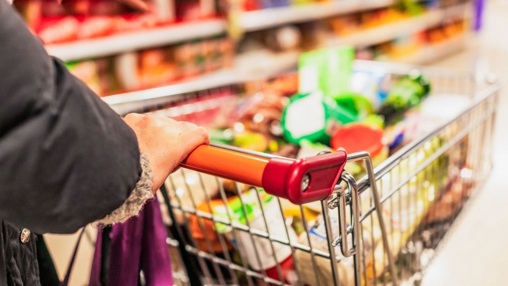 Full shopping trolley in an aisle