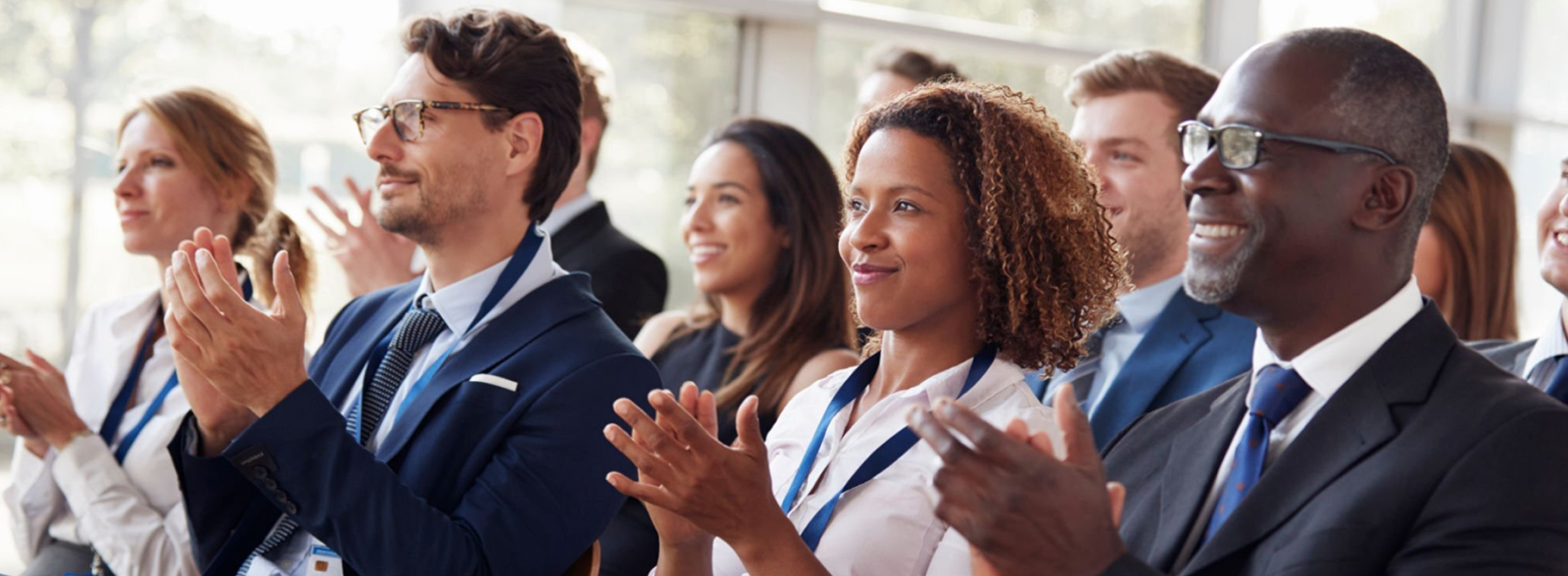 People Looking Left while Seated and Clapping